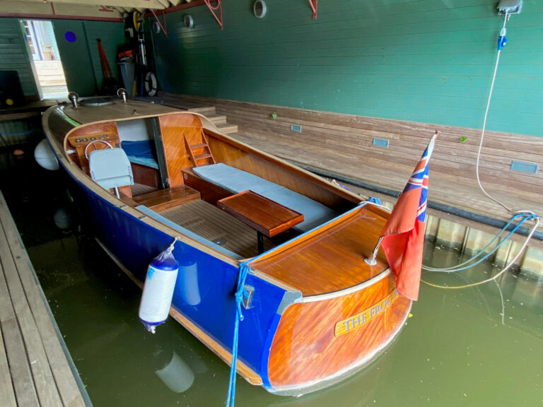 Overhead view of Frog Prince’s interior layout, docked in a covered boathouse.