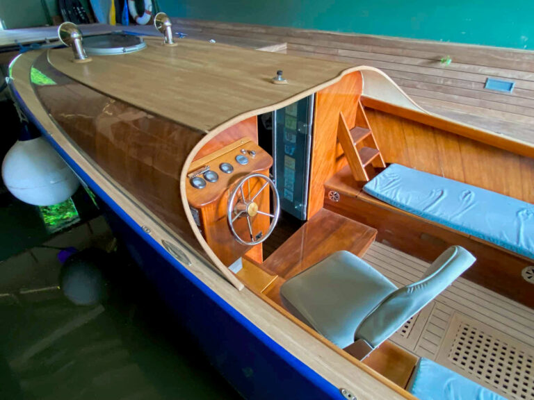 Bow of Frog Prince showing curved deck, mooring lines, and polished roof vents.