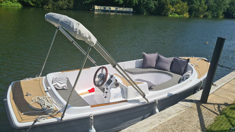 Scoopenhagen helm with mahogany wheel, luxury throttle, and sociable seating layout.